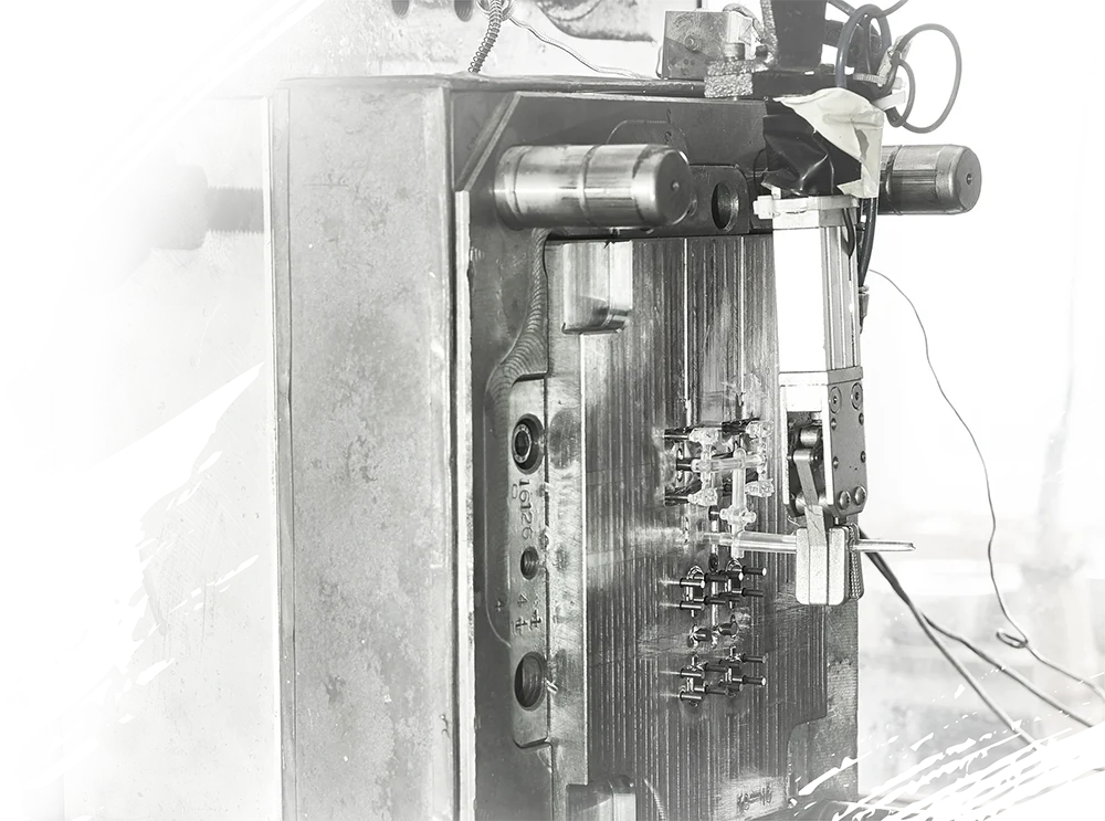 Plastic parts being ejected from an injection molding mold